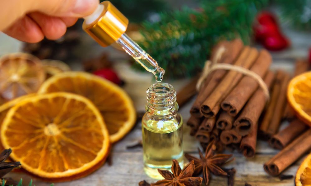 Christmas essential oils in small bottles. Selective focus. Nature.